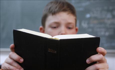 Child holding Bible